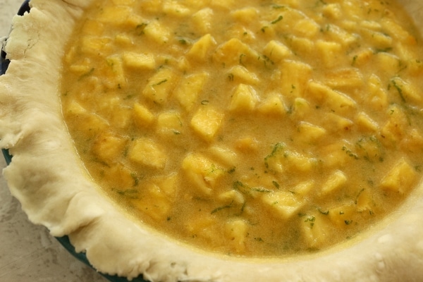 uncooked pineapple pie filling in the pie crust