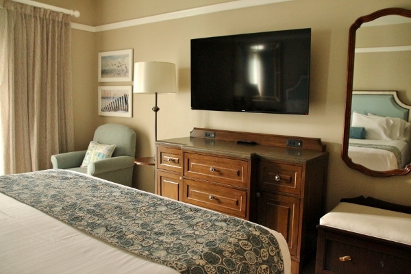 a hotel bedroom with a flat screen television