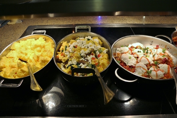 a variety of egg dishes on a breakfast buffet