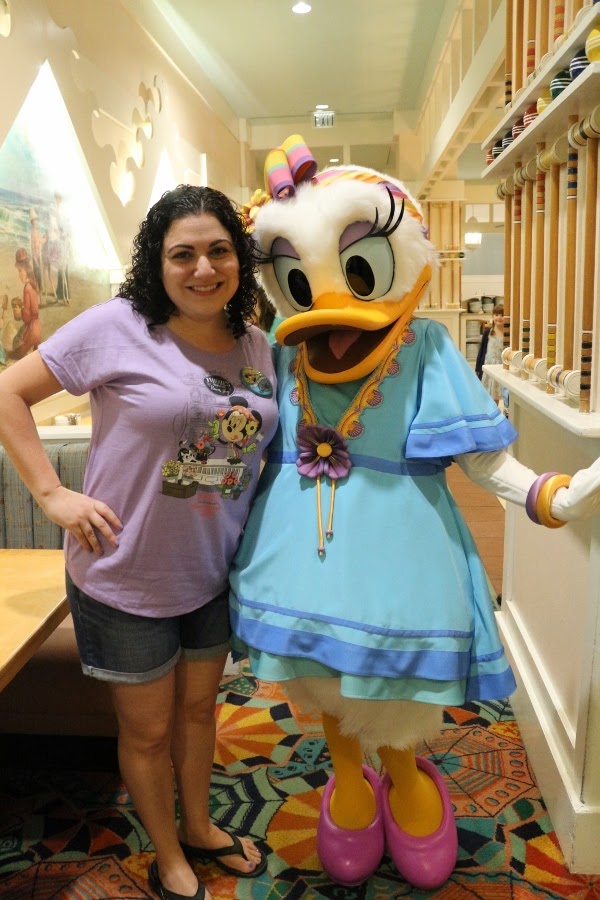 A woman posing with Daisy Duck