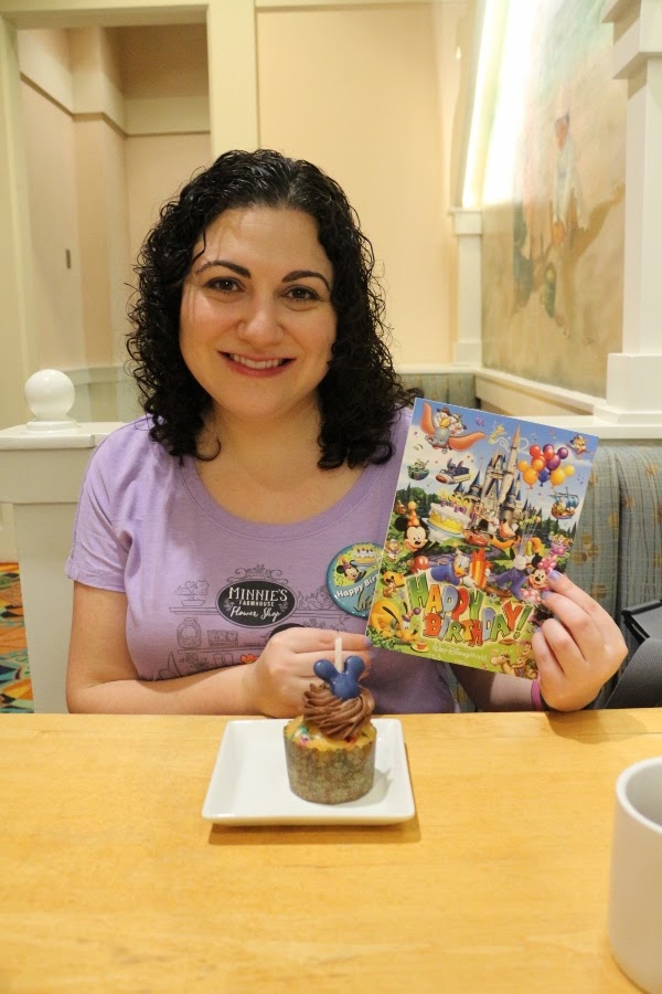 a woman holding a birthday card