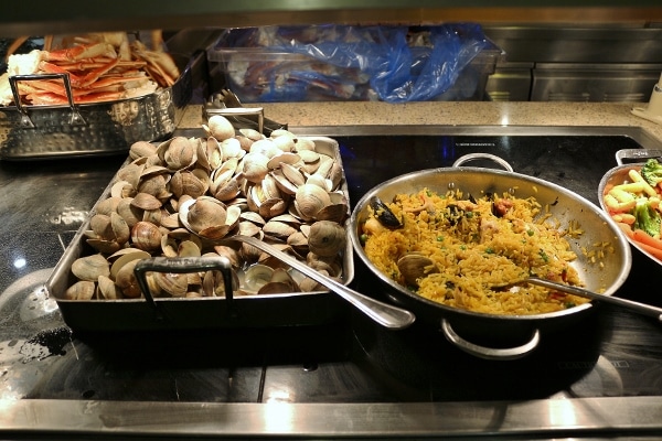 steamed clams and paella on a buffet