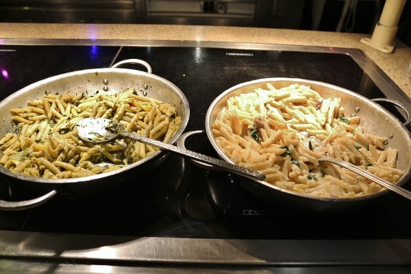 a couple pasta dishes on a buffet