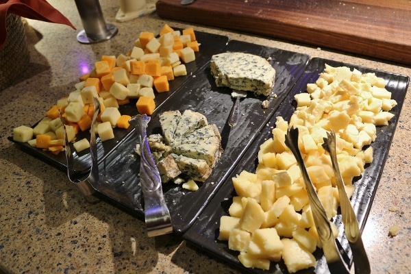 a variety of cheeses on a buffet