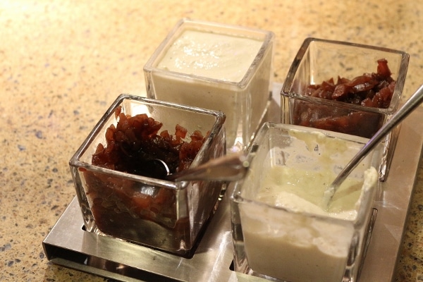 various sauces and toppings in small glass containers