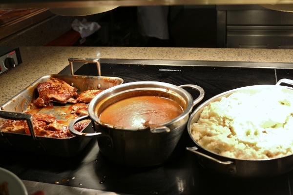 several pans of food on a buffet