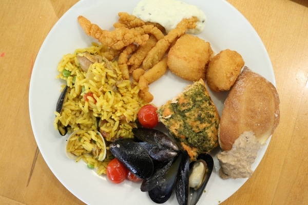 a variety of seafood items from a buffet on a white plate