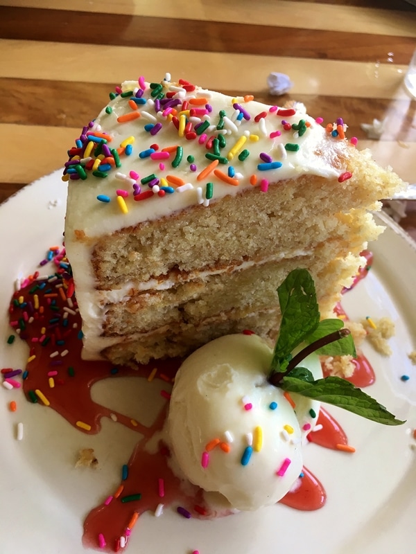 a slice of hummingbird cake with rainbow sprinkles