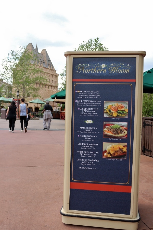 the Northern Bloom menu with the Epcot\'s Canada Pavilion in the distance