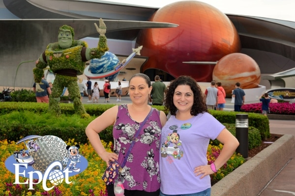 2 woman posing in front of Mission Space