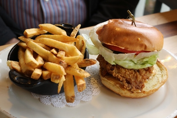 a fried chicken sandwich with fries on a plate