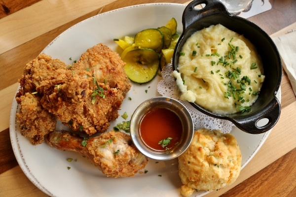 overhead view of a plate of fried chicken with mashed potatoes and hot honey