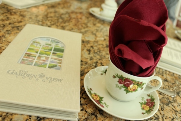 a tea cup and a menu on a table