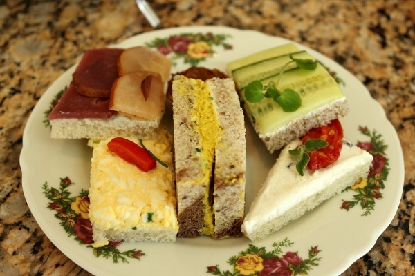 closeup of tea sandwiches on a floral plate