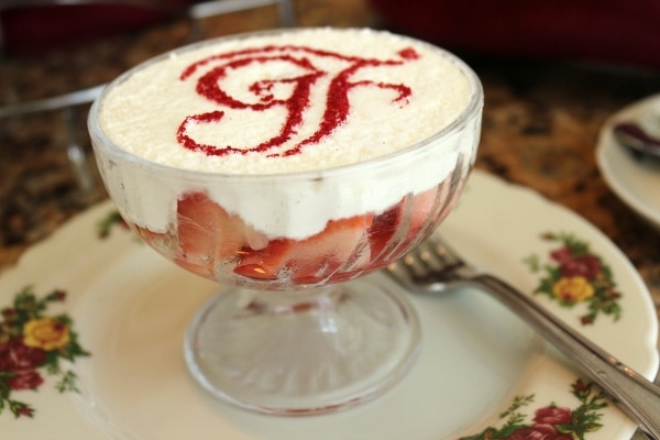 side view of a glass dish of strawberries and cream