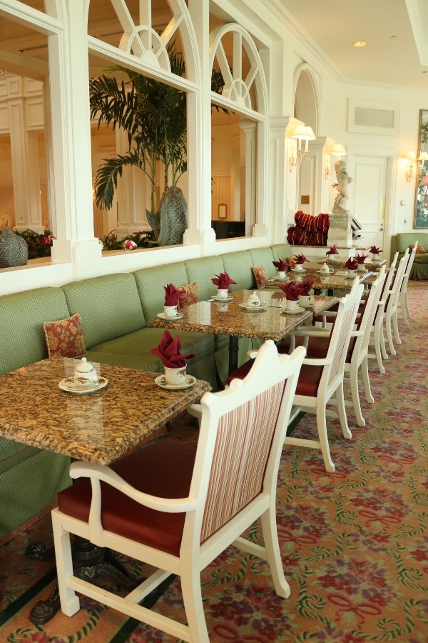 tables in a tea room topped with tea cups