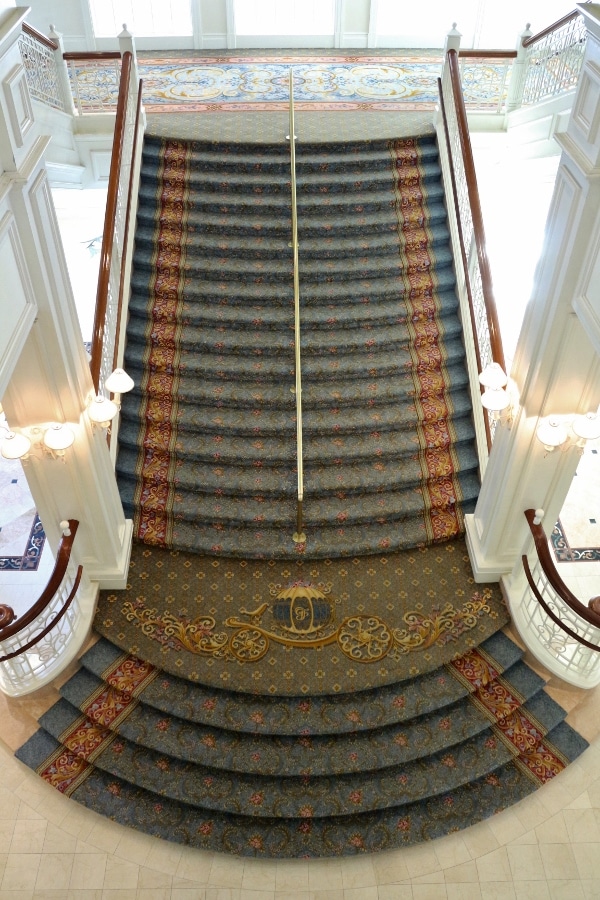 view looking down at a carpeted stairway