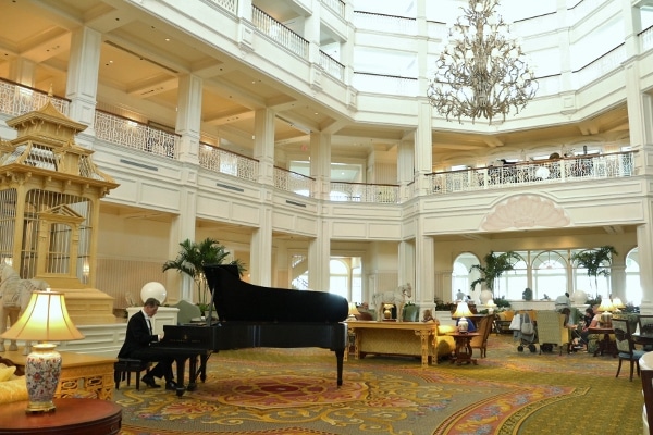 a man playing the piano in the Grand Floridian lobby