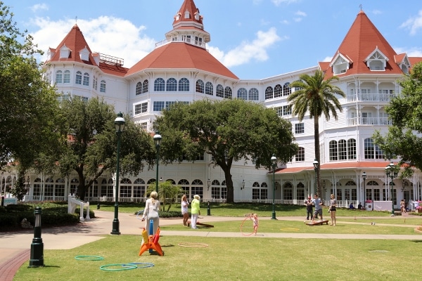 people playing on the lawn outside the Grand Floridian Resort