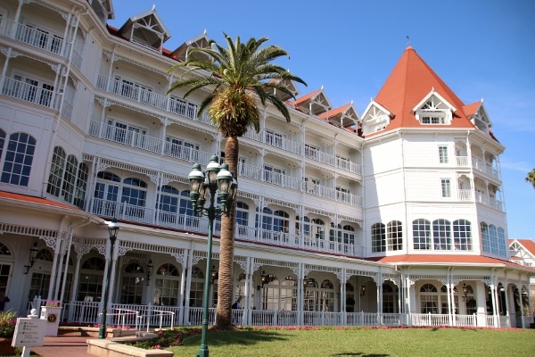 a palm tree with Disney\'s Grand Floridian Resort & Spa in the background