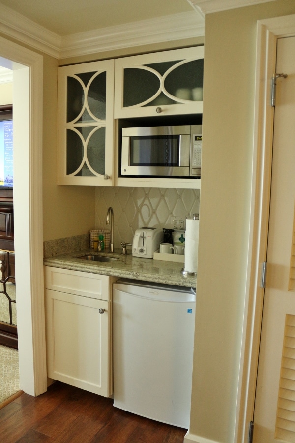 A kitchen with a sink and a microwave