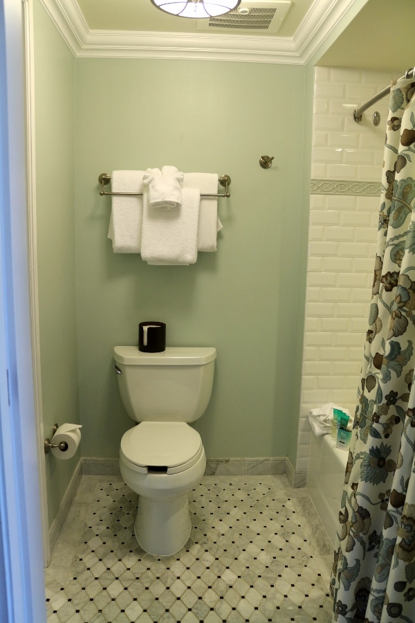 a toilet and bathtub in a hotel bathroom