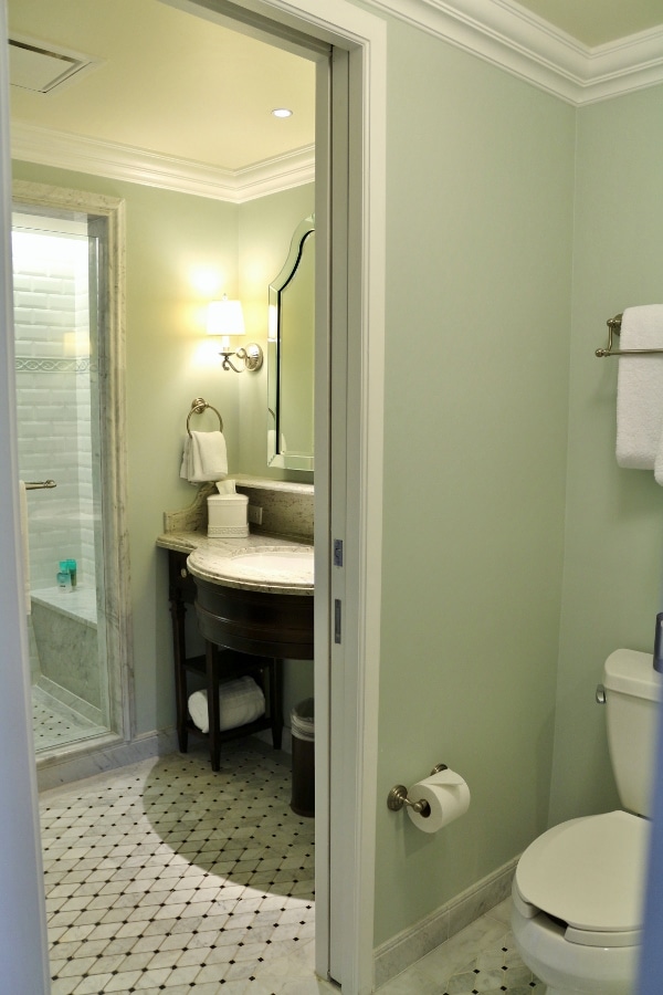 A view of a shower, sink, and toilet