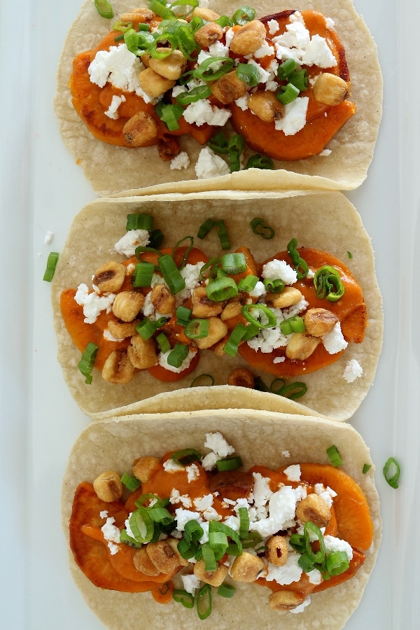 overhead view of 3 sweet potato tacos with feta cheese