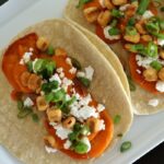 soft tacos with roasted sweet potatoes, feta cheese, corn nuts, and scallions