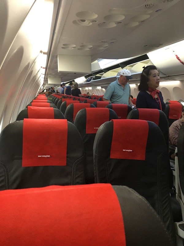 people standing around in an airplane