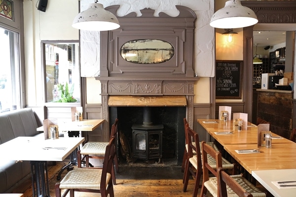 a fireplace inside a restaurant dining room
