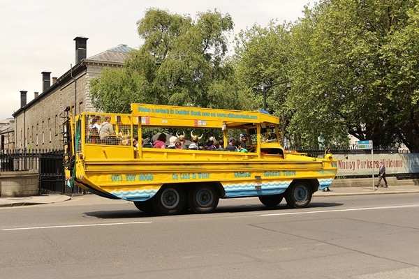 A duck boat driving down the street
