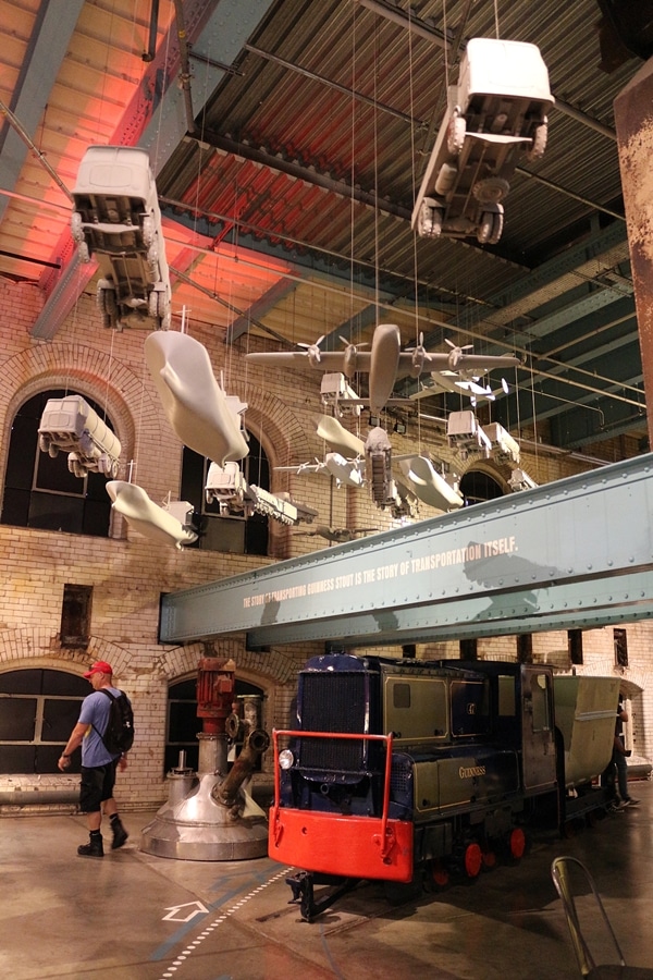 a museum display with travel vehicles hanging from the ceiling