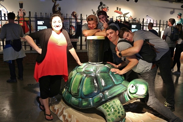 a group of people posing in a museum