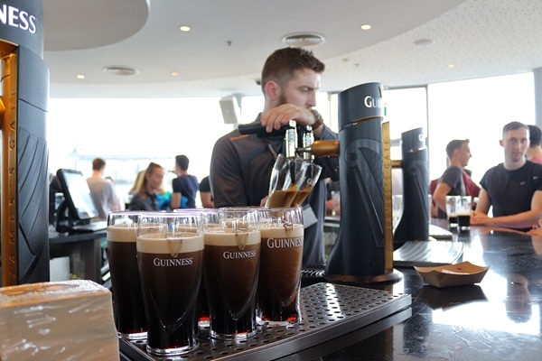 a bartender filling glasses of Guinness