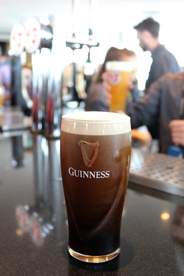 a glass of Guinness on top of a bar