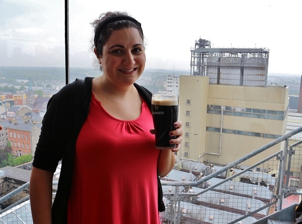 A woman posing with a glass of Guinness