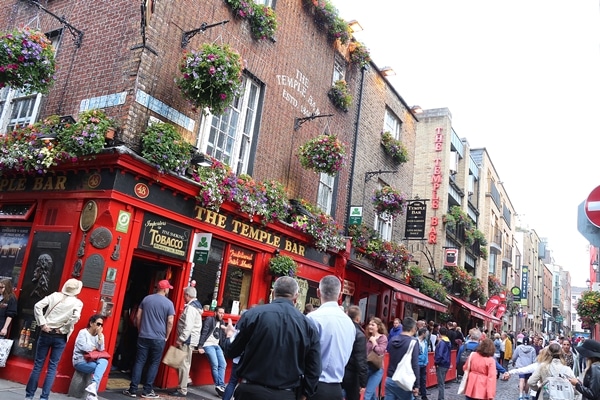 A group of people congregated in front of The Temple Bar