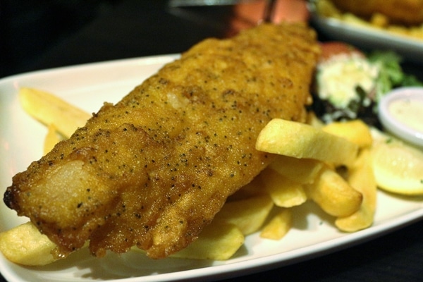 A close up of a plate of fish and chips