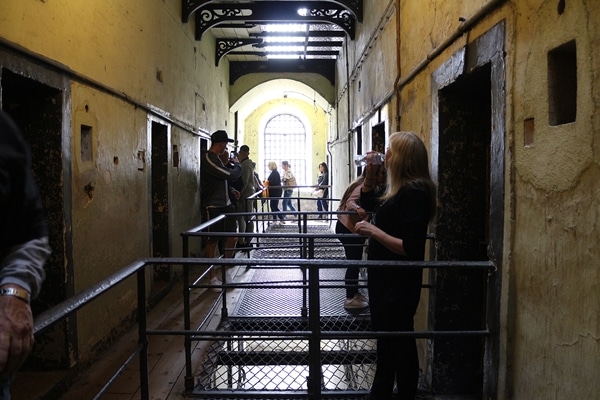 a group of people standing in an old prison building