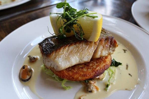 side view of a fillet of fish served over an Irish boxty potato pancake