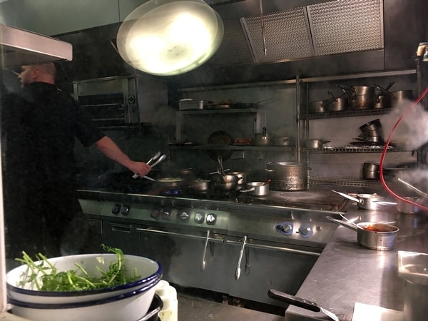 A person cooking in a professional kitchen