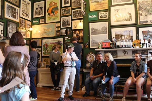 A group of people with a tour guide in The Little Museum of Dublin
