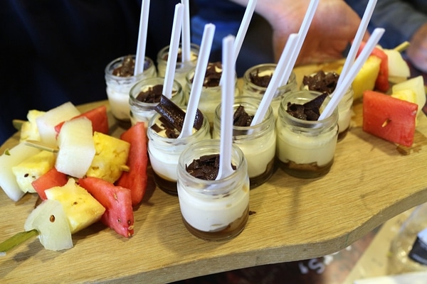 A tray of tiny desserts in jars