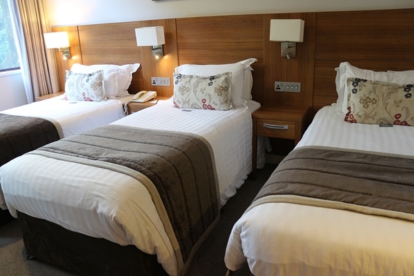 closeup of 3 beds in a hotel room