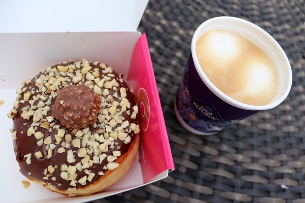 a donut in a box served with a cup of coffee