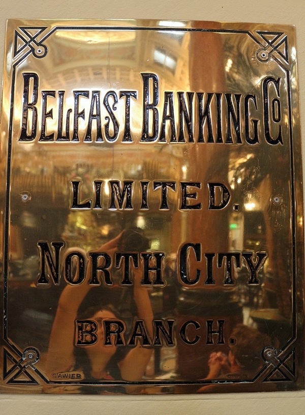 a metal sign that says Belfast Banking Co