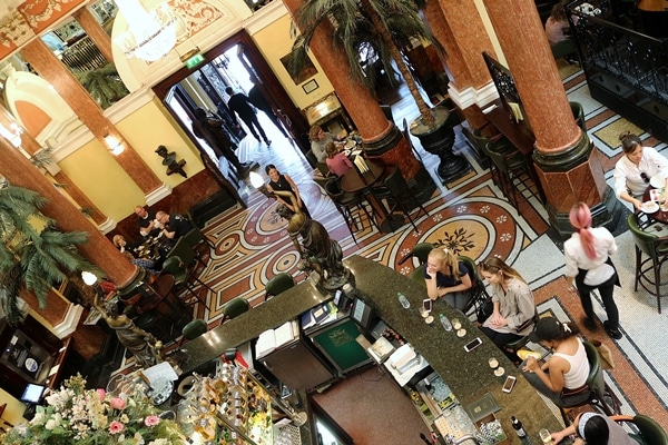 A view looking down into a restaurant from the mezzanine
