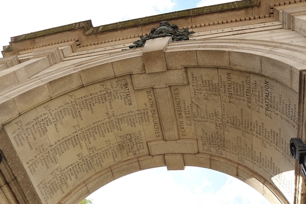 view looking up underneath a stone arch