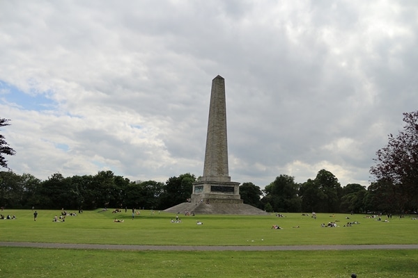 A large stone monument in a grassy field